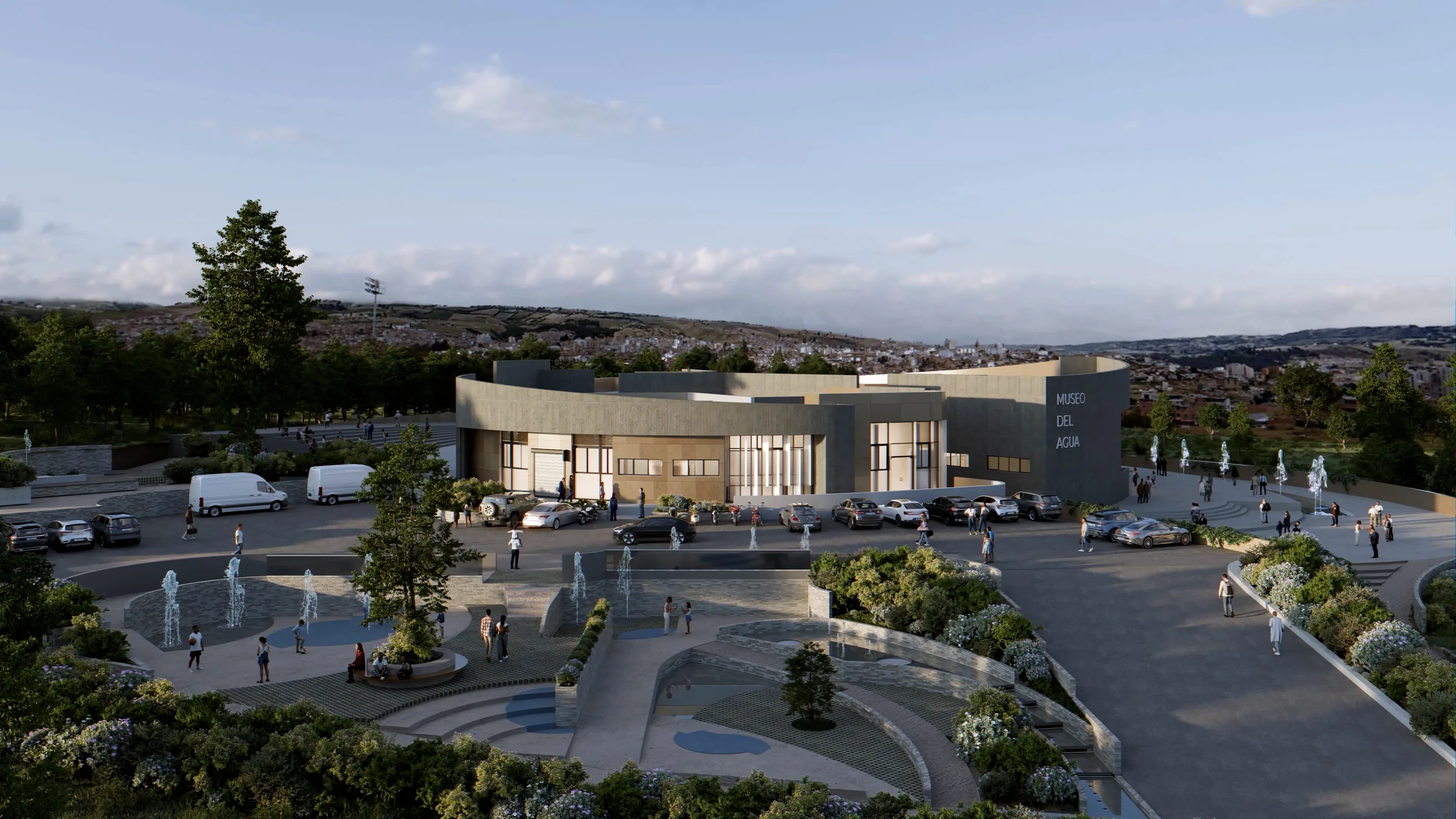 3·6 — Museo del Agua: plaza de fuentes y volumen curvo en piedra al atardecer, Tunja